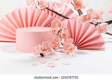 Tender spring stage - cylinder podium mockup, branch lush pink cherry flowers in sunlight, semicircle asian fans on white color, closeup. Template for presentation cosmetic products, goods, branding. - Shutterstock ID 2254787733