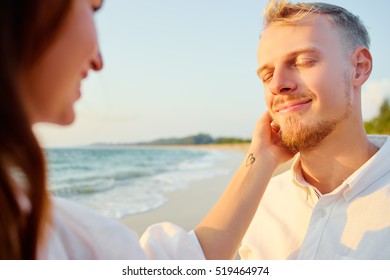 Tender touch. Romantic dating. Close up of happy young loving couple embracing on the sea beach. - Shutterstock ID 519464974