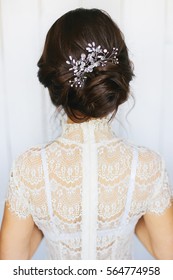 Tender Wedding Stylish Hairstyle With Accessories. Elegant Brunette Bride Standing Back With Collected Up Do Hair. Fine Art Wedding. Light Bridal Morning Preparation.