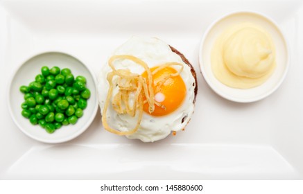 Tenderloin Steak With Fried Egg, Potato Mash And Green Pies Shot From Above