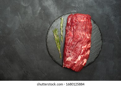 Tenderloin steak. Raw Beef Steak with Rosemary on a black background. 