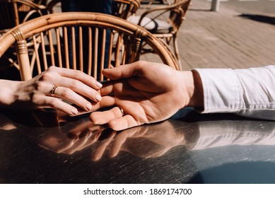 Tenderness. Man's and woman's hands together. Couple touching each other hand.