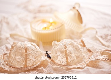Tenderness peachys lingerie with candle and motif. Love mood.