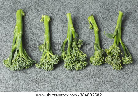Tender-stem broccoli on grey stone background
