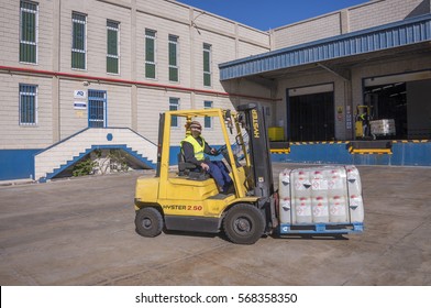TENERIFE, CANARY ISLANDS - FEBRUARY 24, 2016: Loading chemical material, with a forklift, outside the warehouse, in the industrial zone - Shutterstock ID 568358350