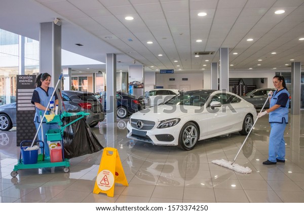 Tenerife, Canary islands, Spain - december 17,\
2015: Women doing cleaning work inside an agency selling and\
distributing cars on the\
island