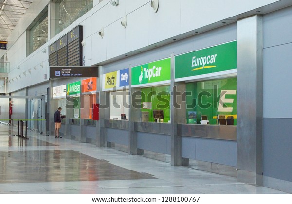 Tenerife South, International Airport, Canary\
Islands, Spain -11-28-2018 : Rental car offices counter inside\
airport terminal