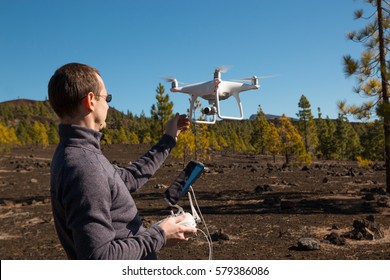 TENERIFE, SPAIN - 13.02.2017: Man With Remote Controlling Drone DJI Phantom 4 In Tenerife, Spain