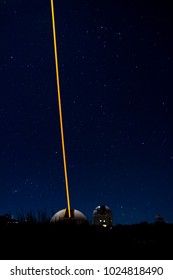 TENERIFE, SPAIN - APRIL 15, 2016: Laser beacon tests at the Teide Observatory in a starry night with Orion constellation in the background. Laser beam clearly visible at naked eye. No post-production.