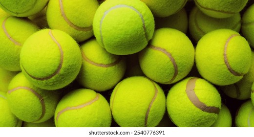 Tennis ball background. A pile of bright yellow tennis balls. Tennis balls stacked together. Close-up of tennis balls showing texture. - Powered by Shutterstock