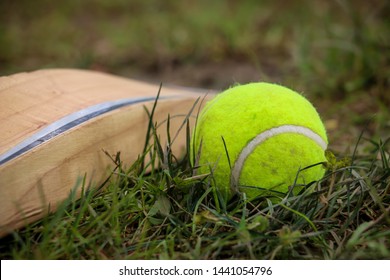 Tennis Ball Cricket. Close Up Of Tennis Ball And Bat Used To Play Cricket