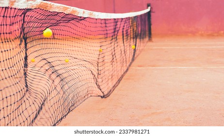 Tennis ball flies into the net at a high speed - Powered by Shutterstock