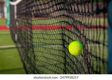 A tennis ball is hitting the net - Powered by Shutterstock