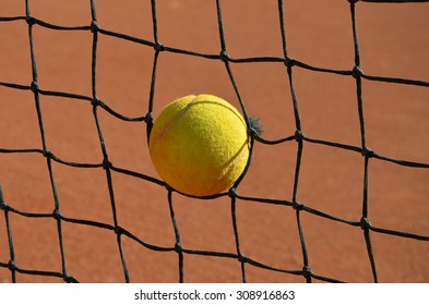 Tennis Ball In The Tennis Net Photo