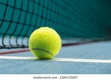 Tennis ball on blue tennis court. the concept of a sporty lifestyle.