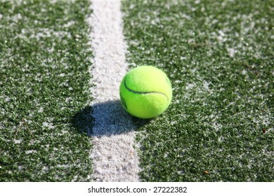 Tennis ball on the court line