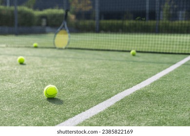 Tennis ball on an empty tennis court - Powered by Shutterstock