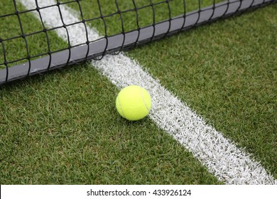 Tennis Ball On Grass Tennis Court