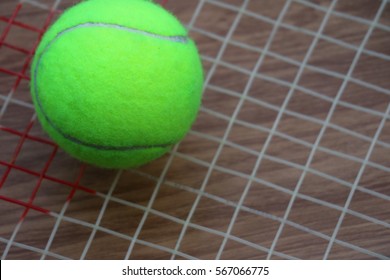 Tennis Ball On Racket Net On Wood Background, Sport Equipment