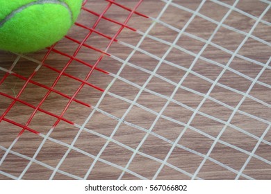 Tennis Ball On Racket Net On Wood Background, Sport Equipment