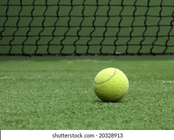 Tennis ball on synthetic grass of tennis court.