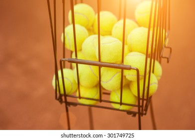 Tennis balls in the basket on the background of the tennis court - Powered by Shutterstock