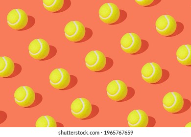 Tennis balls on pastel orange background. Minimal tennis pattern. Champion mood. Green balls pattern. Tennis tournament.