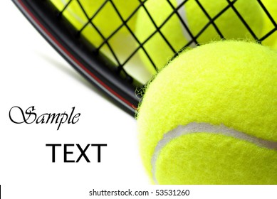 Tennis balls and racquet on white background with copy space.  Macro with shallow dof.