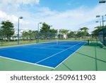 The tennis court is empty in a luxurious villa complex