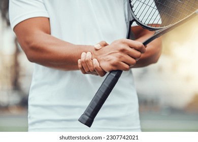 Tennis court, hand injury and man with racket for sports, fitness and match with discomfort or bruise. Joint pain, wrist and male player with arthritis, osteoporosis or fibromyalgia during training - Powered by Shutterstock