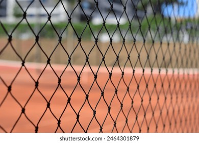 Tennis court screen with blurred background with clay floor - Powered by Shutterstock