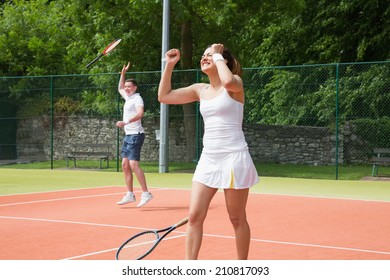 Tennis Doubles Team Celebrating A Win On A Sunny Day