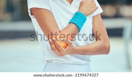 Tennis elbow, pain and injury with a sports woman holding her joint during training, workout and exercise. Fitness, health and accident with a female athlete in a game or match on a court outside