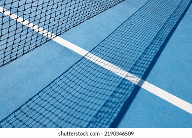 Tennis Net On Blue. Part Of A Tennis Net And Its Shadow. Dynamic Perspective