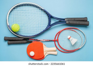 Tennis paddle rackets with ball on grey background. Summer sport activity concept. Top view - Powered by Shutterstock