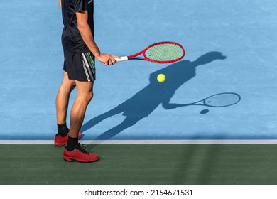 Tennis Player Bouncing Ball Near Base Line On Blue Hard Court Befor Service, Starting Match. Sports Active Play Tennis Background With Copy Space. Tennis Tournament Concept