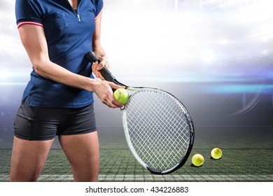 Tennis player holding a racquet ready to serve against american football arena - Powered by Shutterstock