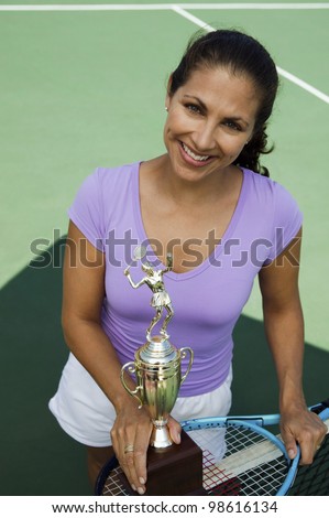 Tennis Player Holding Trophy