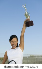 Tennis Player Holding Trophy Aloft