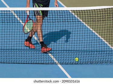 Tennis Player With Racket And Ball On Blue Hard Tennis Court Near Net. Sports, Active Game Background, Tennis Tournament, Match Concept.