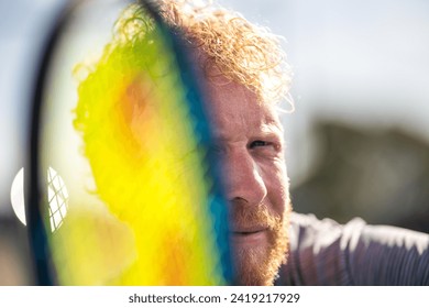 tennis player ready to return serve out in the sun on a tennis court in summer  - Powered by Shutterstock