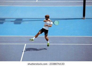 Tennis player training on a professional tennis court. - Powered by Shutterstock