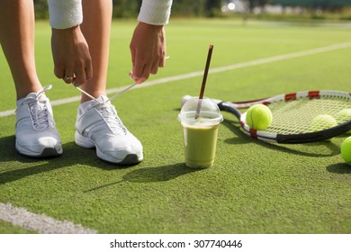 Tennis player tying shoes - Powered by Shutterstock