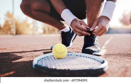 Tennis player tying sport shoes. Sport, recreation concept