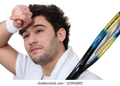 Tennis Player Wiping The Sweat From His Brow