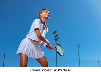 Tennis player woman with racket on the court outdoors. Download a photo of a tennis player girl to advertise sporting events in social media. Vertical photo for stories, reels or shorts. - Powered by Shutterstock