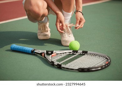 Tennis player woman, shoelace and ready for game, training or exercise sneakers in development, sports or focus. Sport expert, girl athlete and professional shoes with tennis ball, racket and goals - Powered by Shutterstock