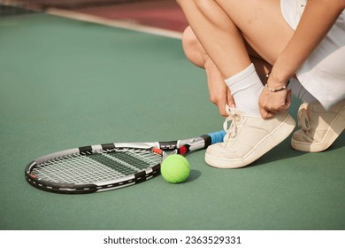 Tennis player woman, shoelace and ready for game, training or exercise sneakers in development, sports or focus. Sport expert, girl athlete and professional shoes with tennis ball, racket and goals - Powered by Shutterstock