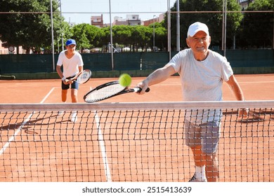 Tennis players of different generations playing tennis - Powered by Shutterstock