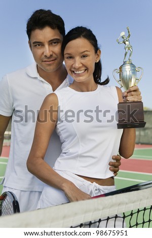 Tennis Players Holding Trophy